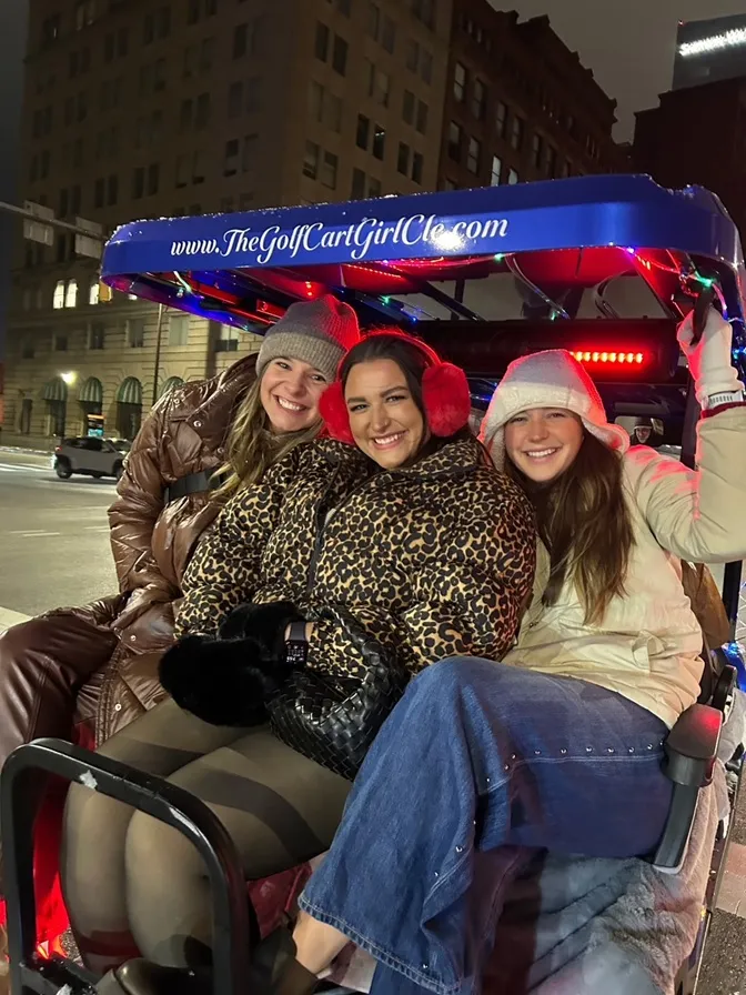 Riders posing during a Cleveland golf cart experience.