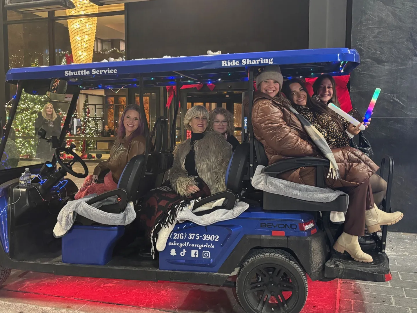 Friends posing during a Cleveland golf cart experience.