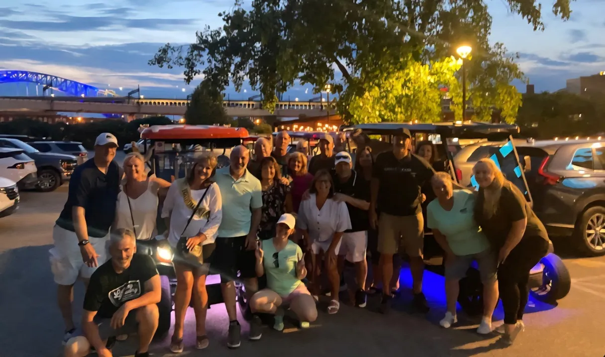 A group posing during a Cleveland brewery cart experience.