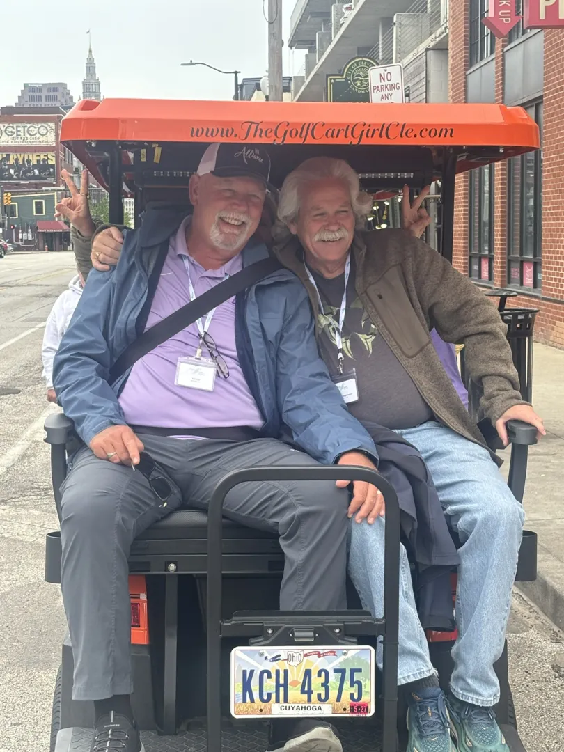A group smiling during a Cleveland cart ride.