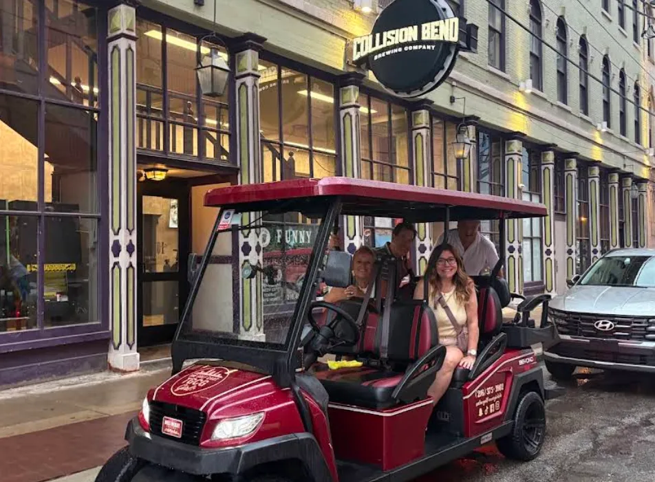 The Golf Cart Girl-CLE cart parked outside Collision Bend with riders smiling on board