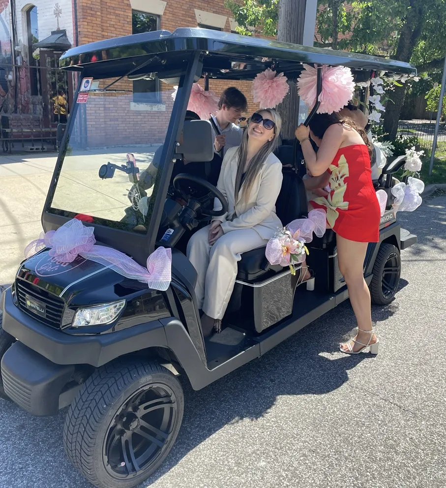 Wedding guests posing with The Golf Cart Girl-CLE cart service.